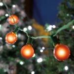 25 G40 Globe String Light Set with Orange Satin Bulbs on Green Wire