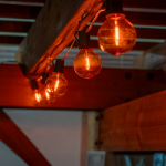 25 LED Filament G40 Globe String Light Set with Transparent Orange Bulbs on Brown Wire
