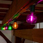 25 LED Filament G40 Globe String Light Set with Transparent Yellow, Purple & Green Bulbs on Green Wire